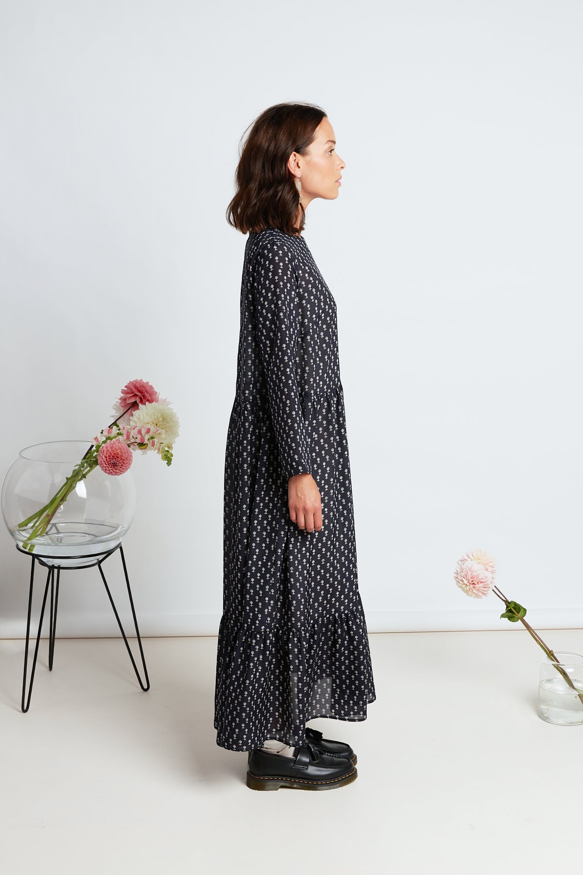 Alida dress by twenty-seven names. Silk maxi dress with long sleeves, simple bodice, pleated skirt, and gathered hem tier. Navy silk with micro ditsy floral motif print.