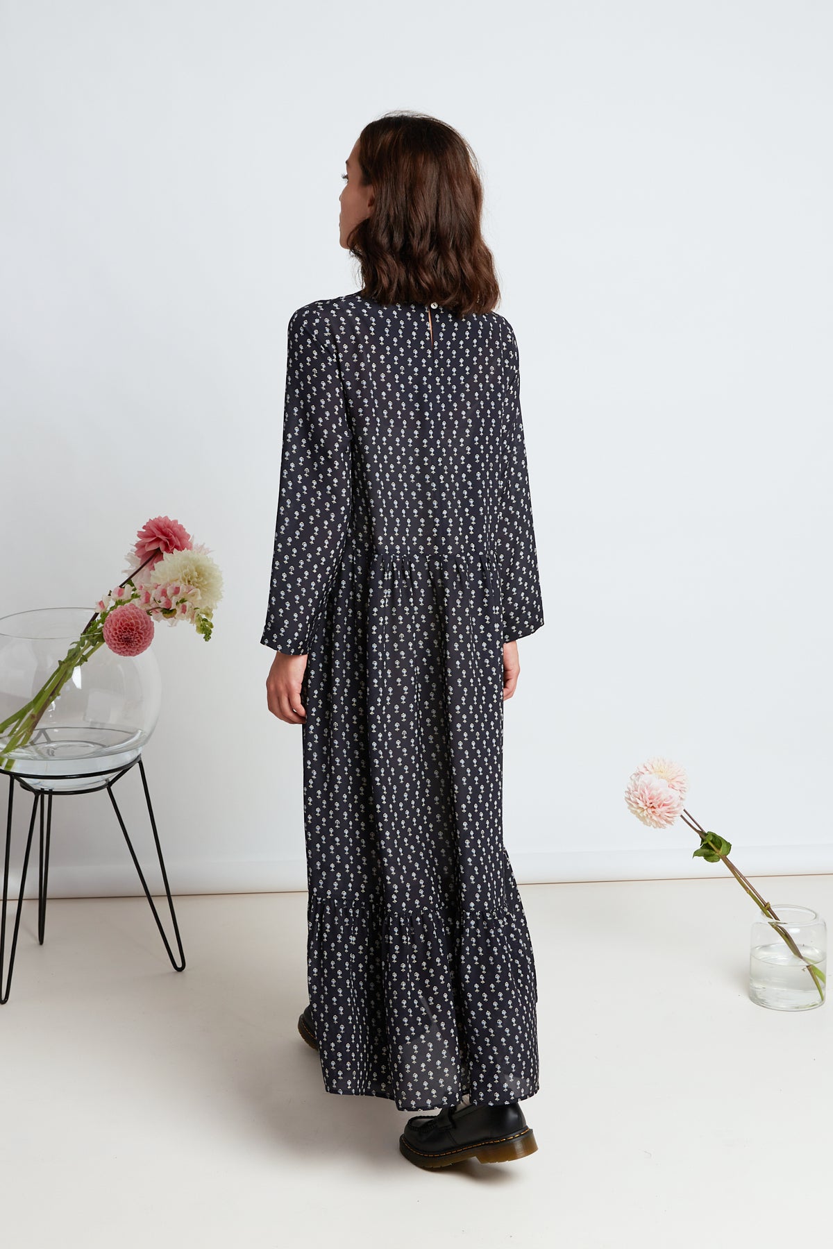 Alida dress by twenty-seven names. Silk maxi dress with long sleeves, simple bodice, pleated skirt, and gathered hem tier. Navy silk with micro ditsy floral motif print.