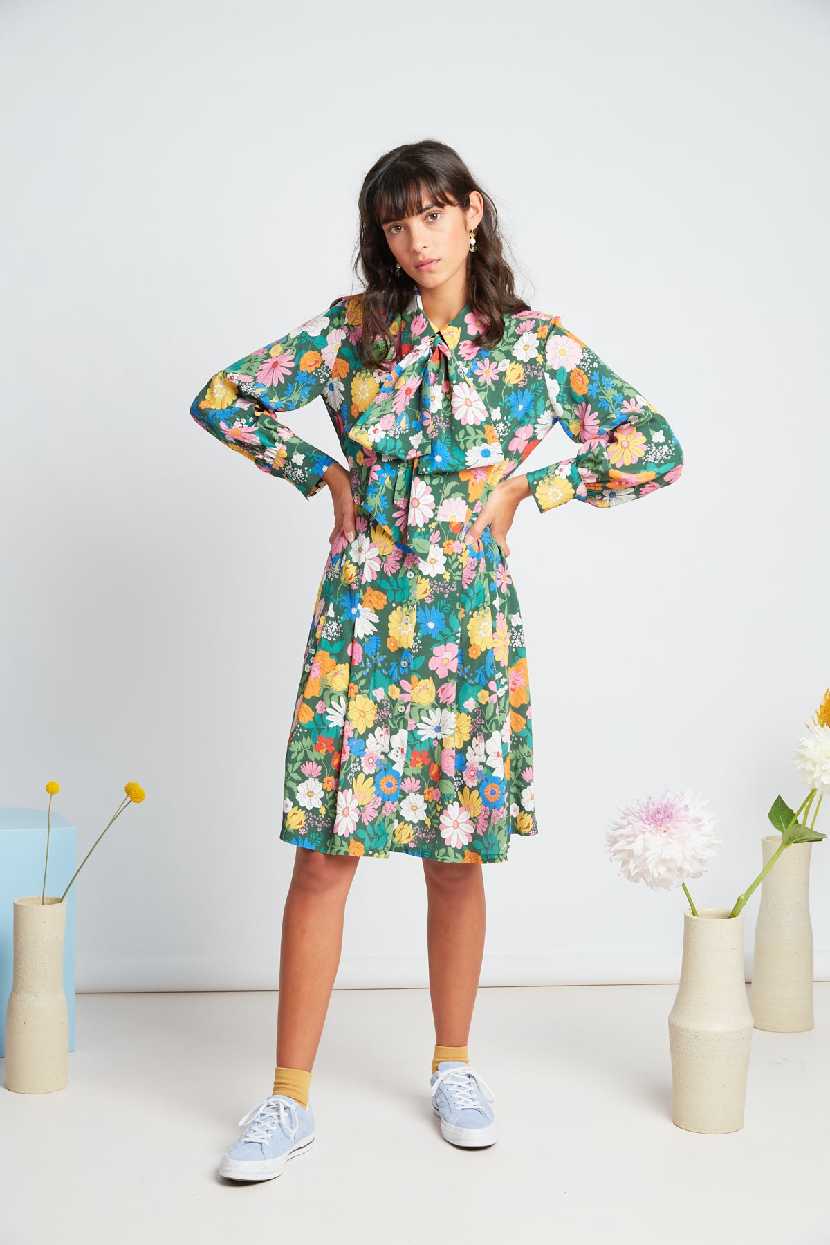 Bouquet dress by twenty-seven names. Long-sleeved shirt dress, with a set waist and dart shaping, gathered sleeves, and an optional big pussy bow accessory.  Custom TSN Botanical print - multi coloured on a green base.