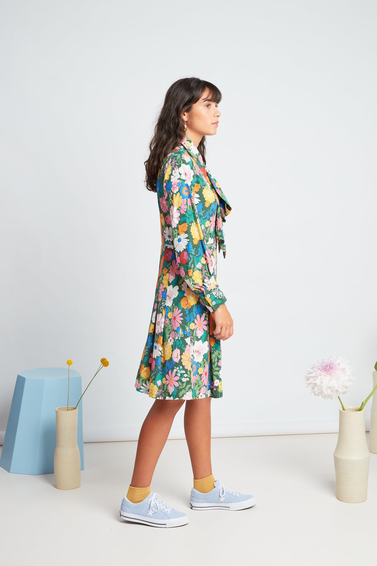 Bouquet dress by twenty-seven names. Long-sleeved shirt dress, with a set waist and dart shaping, gathered sleeves, and an optional big pussy bow accessory.  Custom TSN Botanical print - multi coloured on a green base.