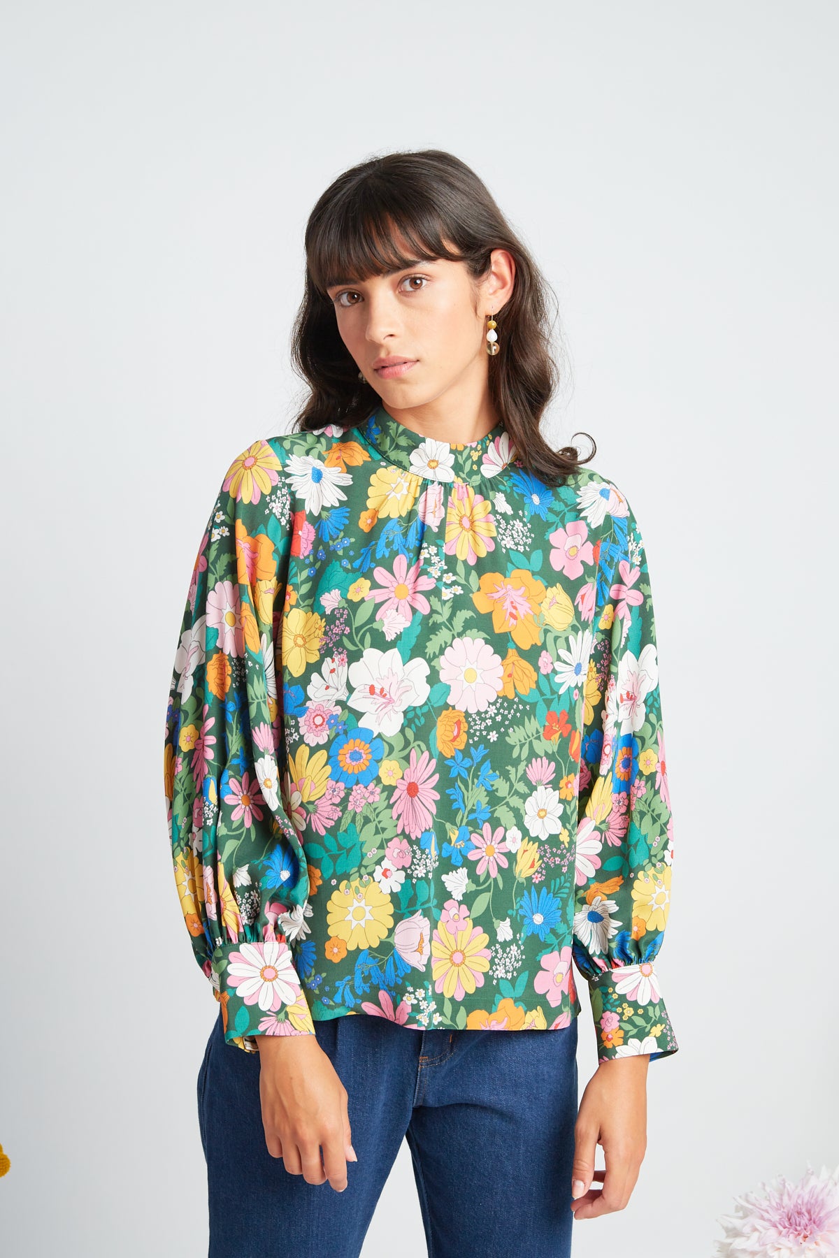 Manuela blouse by twenty-seven names. An elegant long-sleeved blouse with a high-neck panel, and gathers at the neck and cuff. Pictured in Periwinkle - multi colour custom Botanical print on green base.