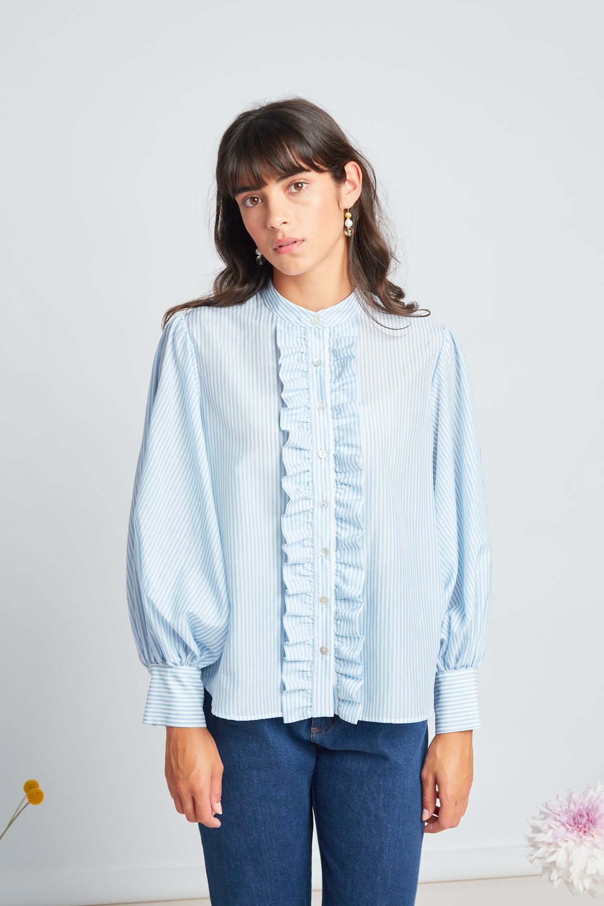 Forget-me-not blouse by twenty-seven names. Soft forget-me-not blue and white silk-cotton stripe blouse with long, exaggerated gathered sleeves, a frill down the front placket, and an optional big bow accessory.