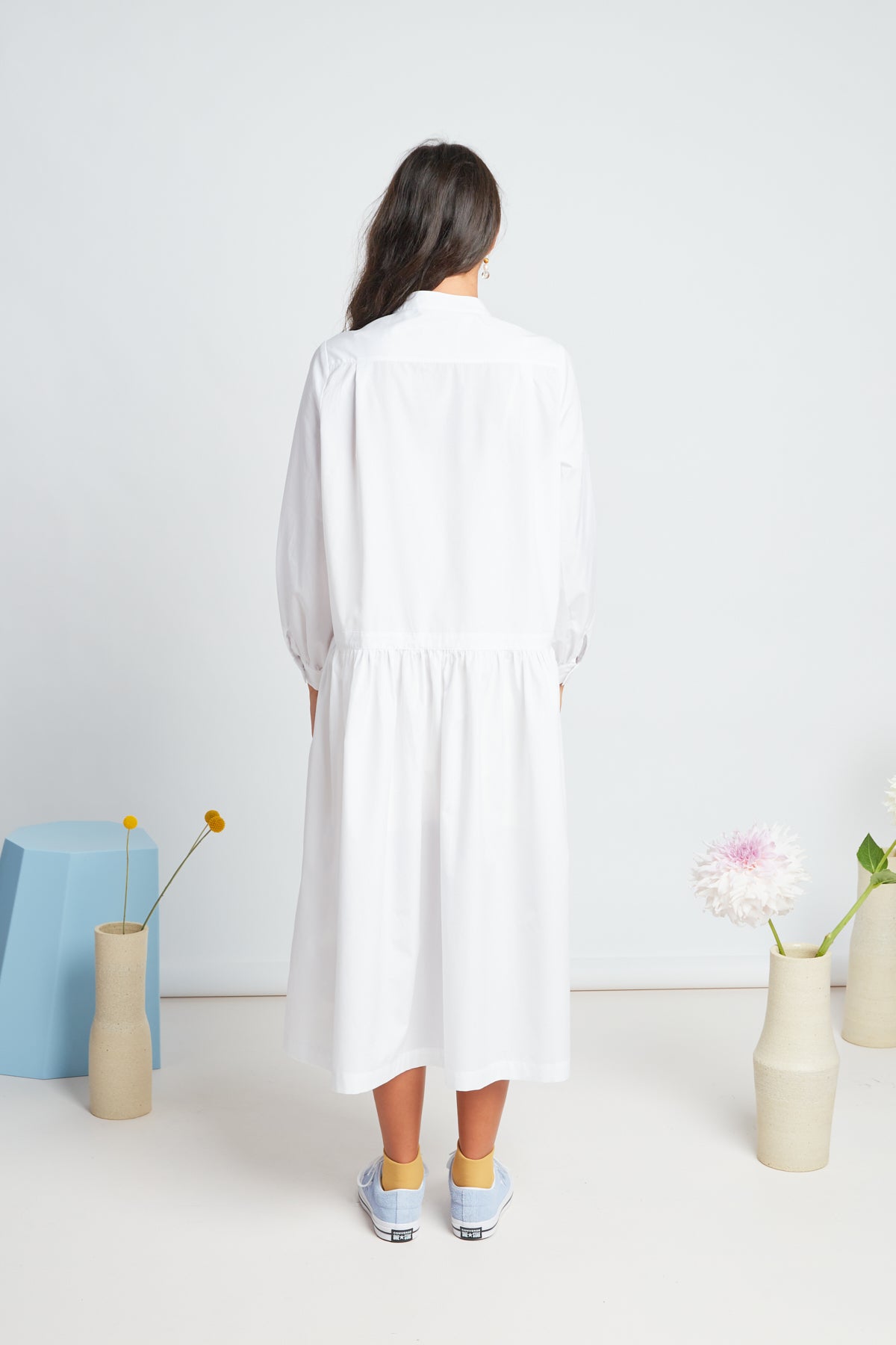 Sade dress by twenty-seven names. A crisp shirt dress in organic cotton, with half placket at the neck, and a dropped waist skirt. Pictured in white.