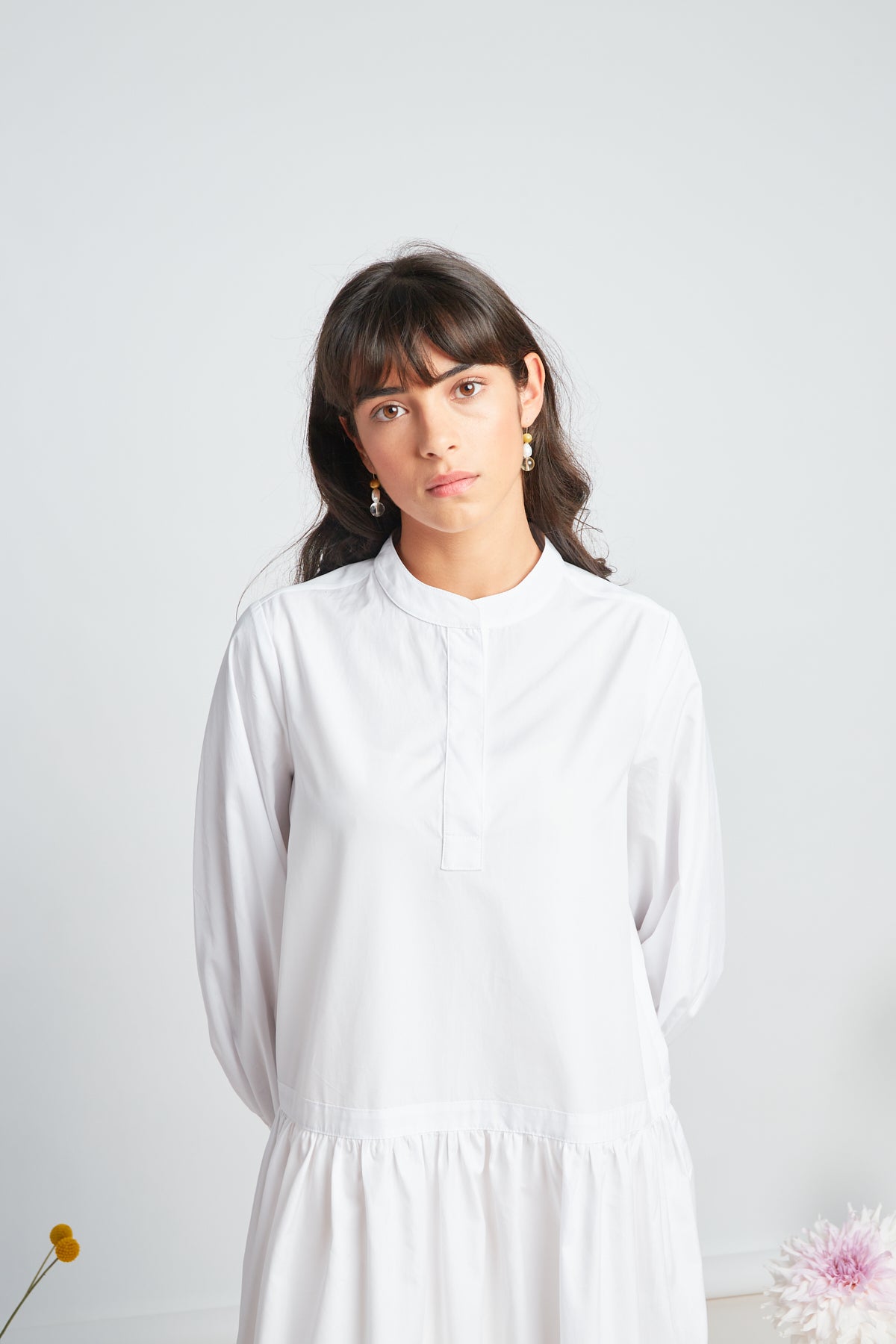 Sade dress by twenty-seven names. A crisp shirt dress in organic cotton, with half placket at the neck, and a dropped waist skirt. Pictured in white.