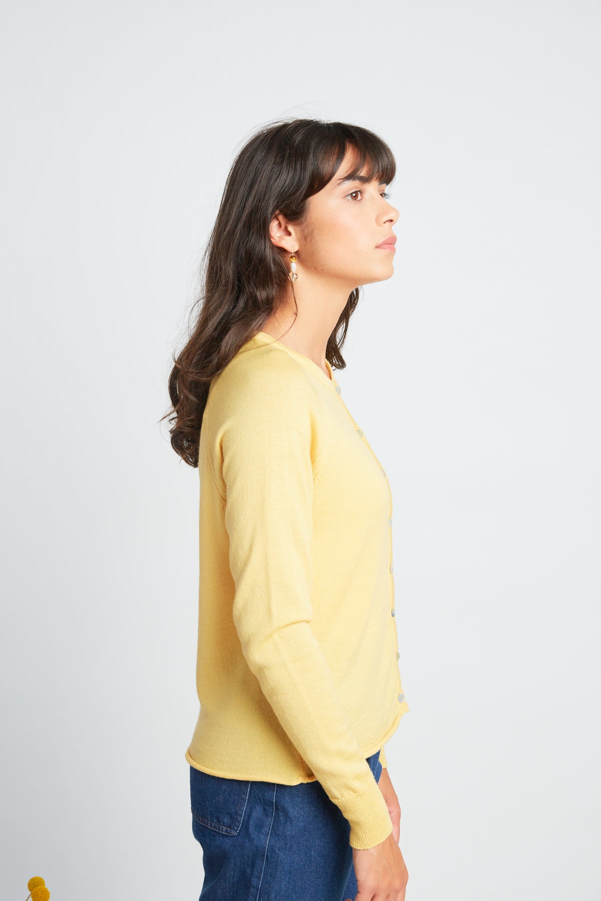 Daybreak cardigan by twenty-seven names. A chic little light-weight merino cardigan with raglan sleeves and shell buttons. Pictured in soft yellow.