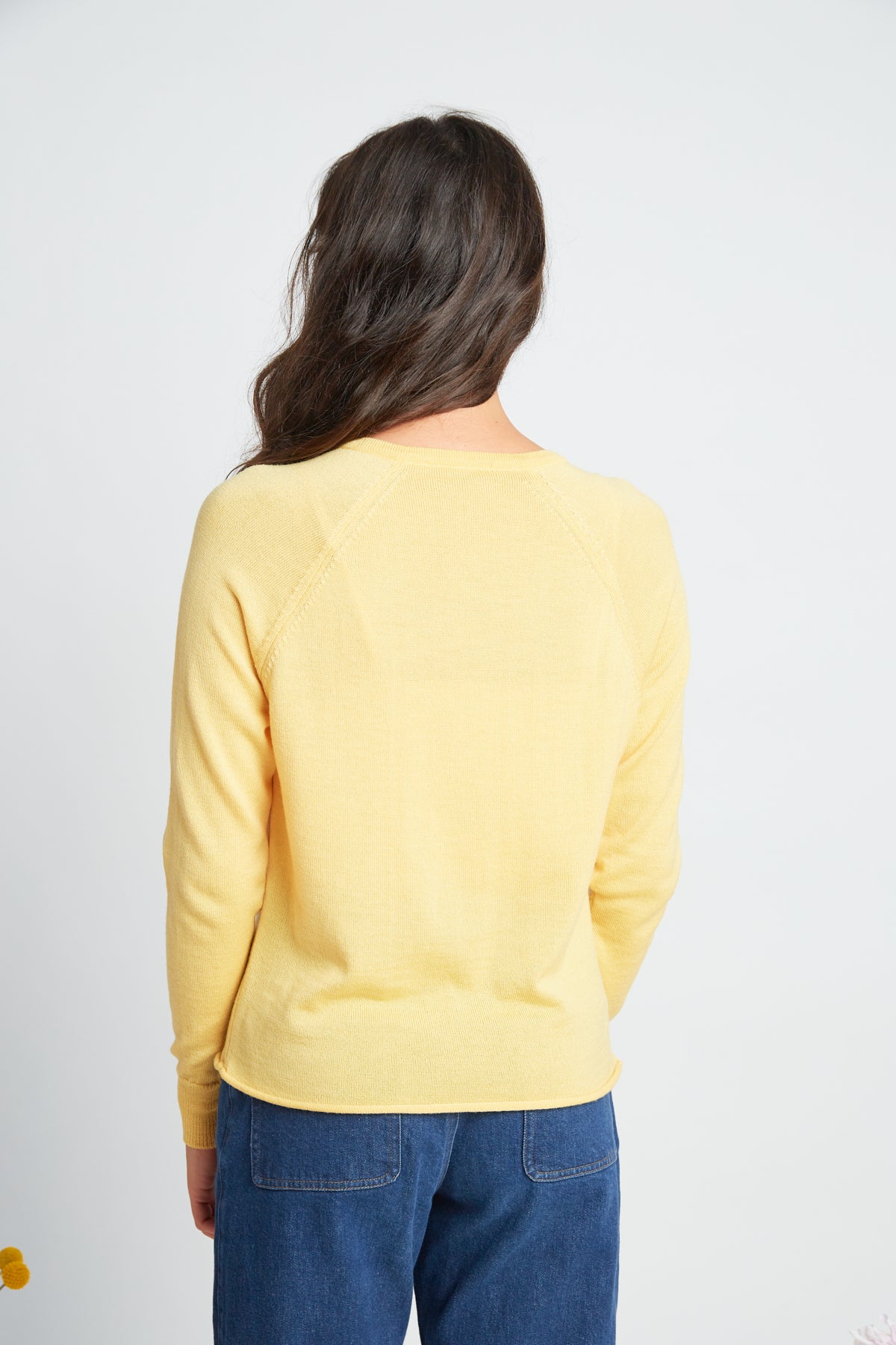 Daybreak cardigan by twenty-seven names. A chic little light-weight merino cardigan with raglan sleeves and shell buttons. Pictured in soft yellow.