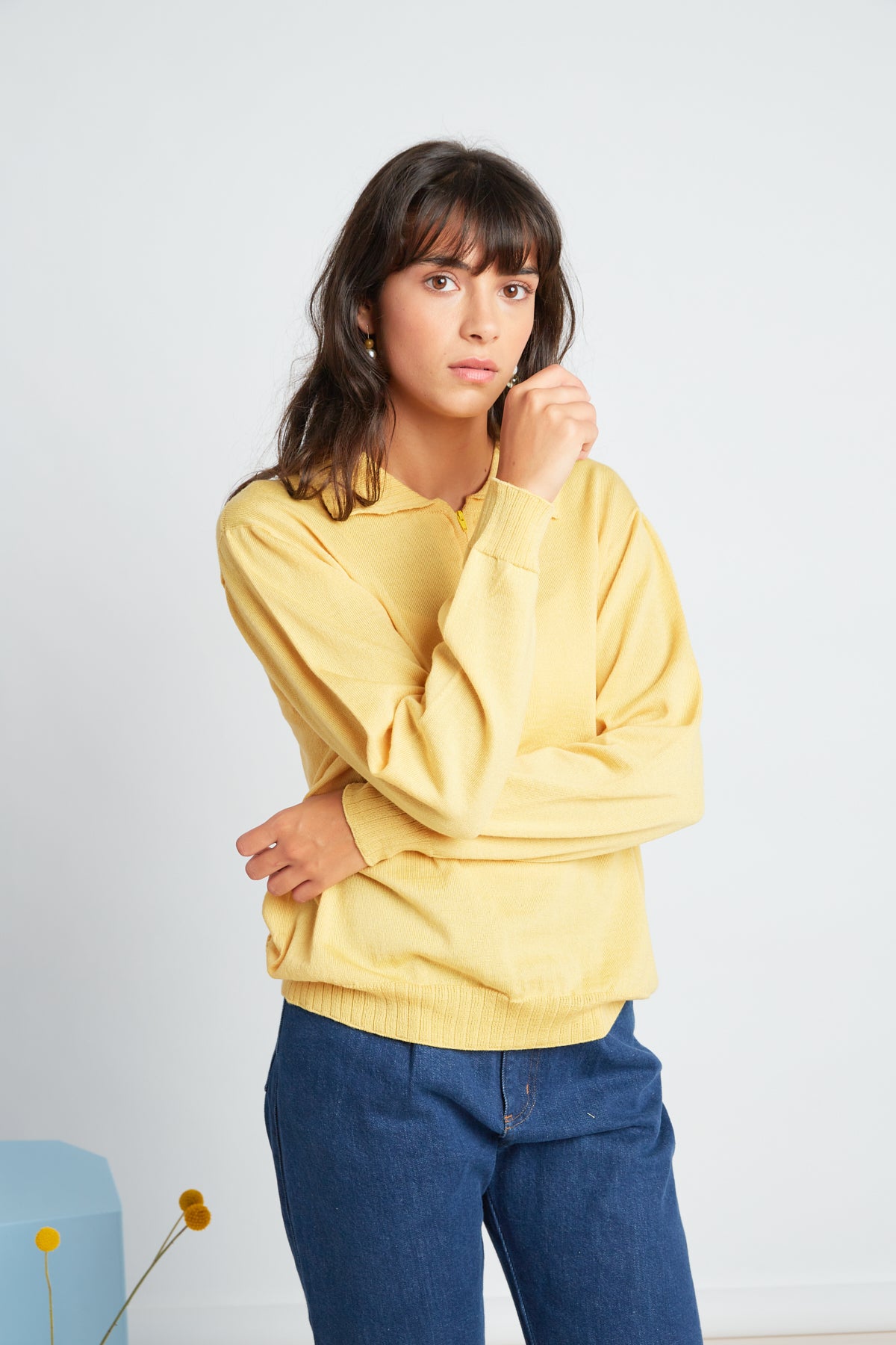 Katie jumper by twenty-seven names. A light-weight 100% merino sweater with a zip at the centre-front and a little collar. Pictured in soft yellow.